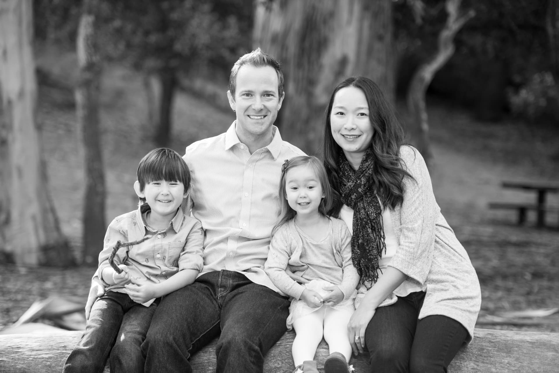 Family of four photographed together beneath the eucalyptus trees